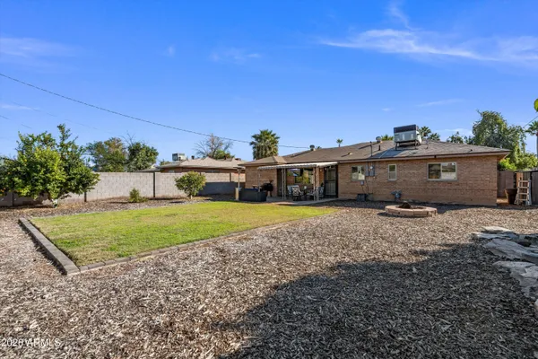 a view of a patio with table and chairs and potted plants