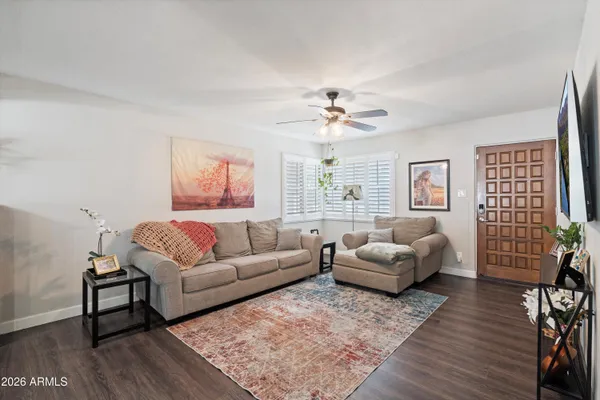 a living room with furniture a couch and a chandelier