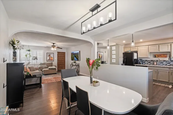 a view of a dining room with furniture and wooden floor