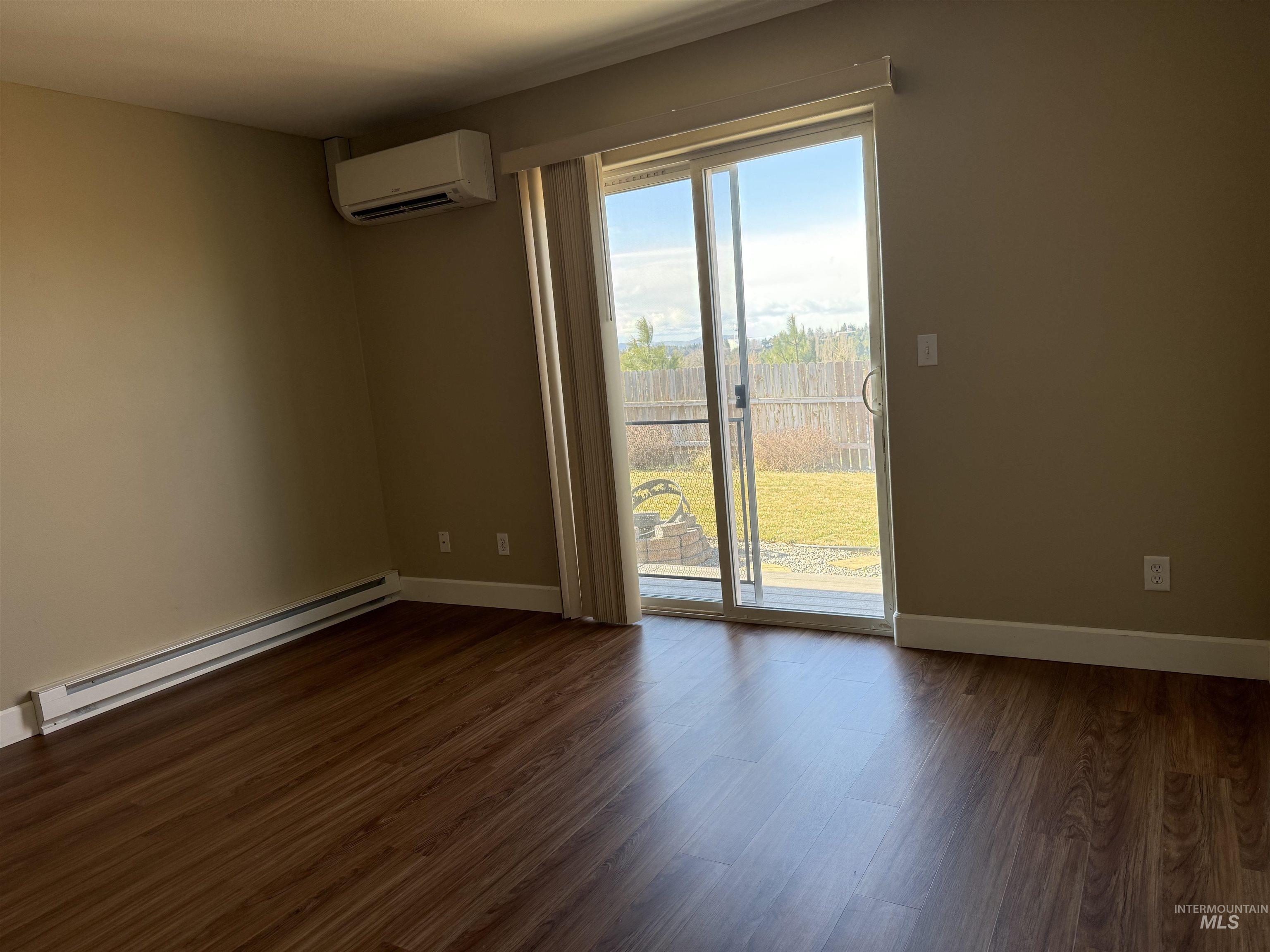 257 Pintail Lane Moscow, ID 83843 - Photo 14 of 28 Spare room featuring a baseboard heating unit, dark wood-type flooring, and a wall mounted mini split