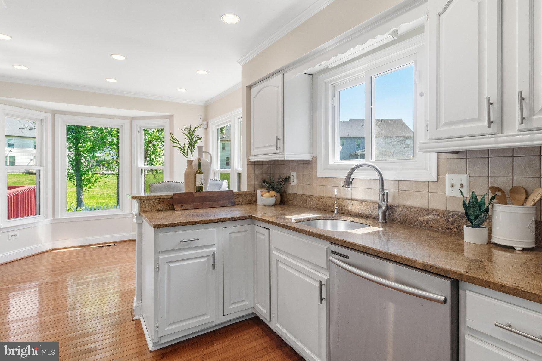 14215 Greenview Drive Laurel, MD 20708 - Photo 11 of 35 a kitchen with sink cabinets and wooden floor
