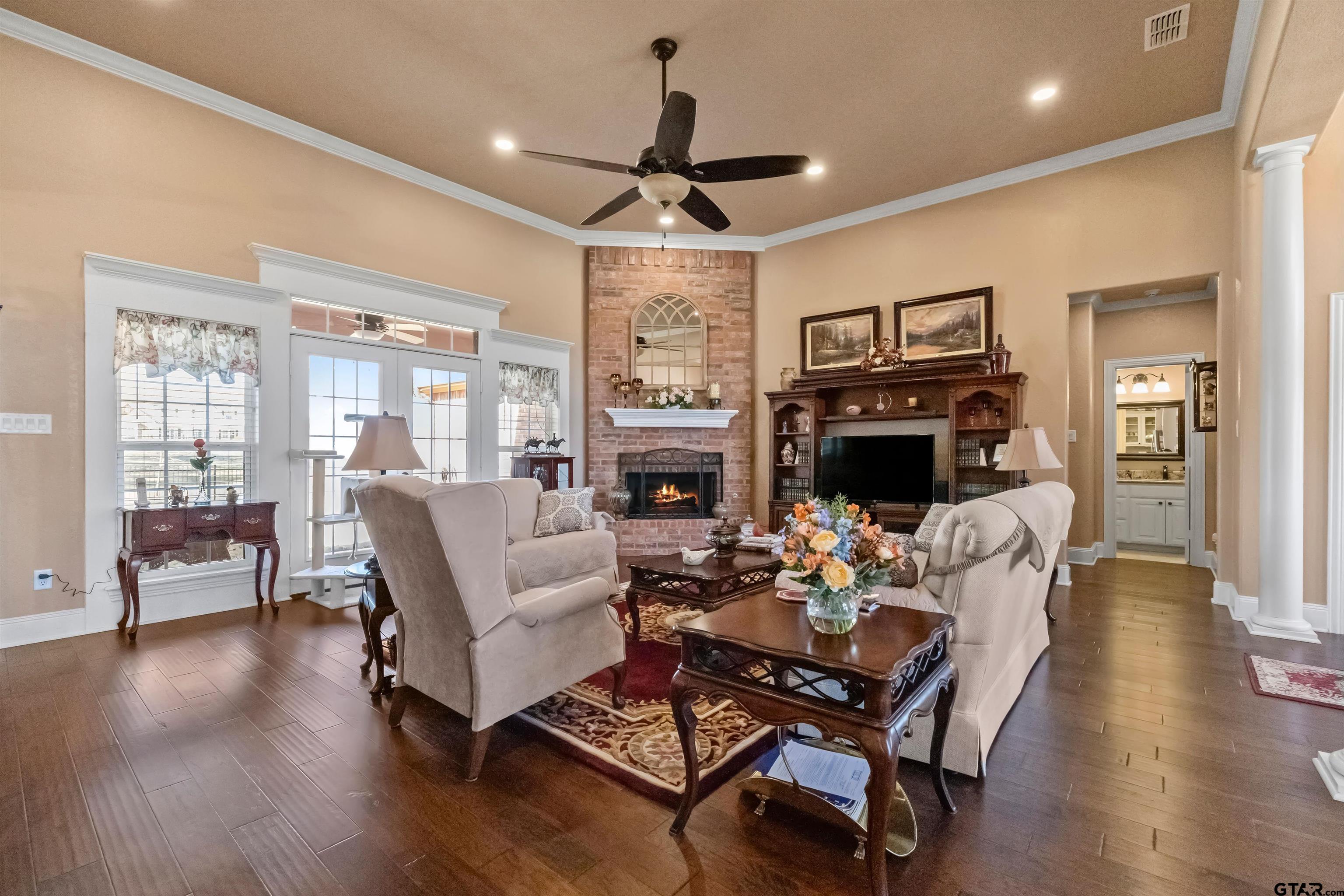 8499 Fm 856 Street Troup, TX 75789 - Photo 12 of 47 a living room with fireplace furniture and a wooden floor