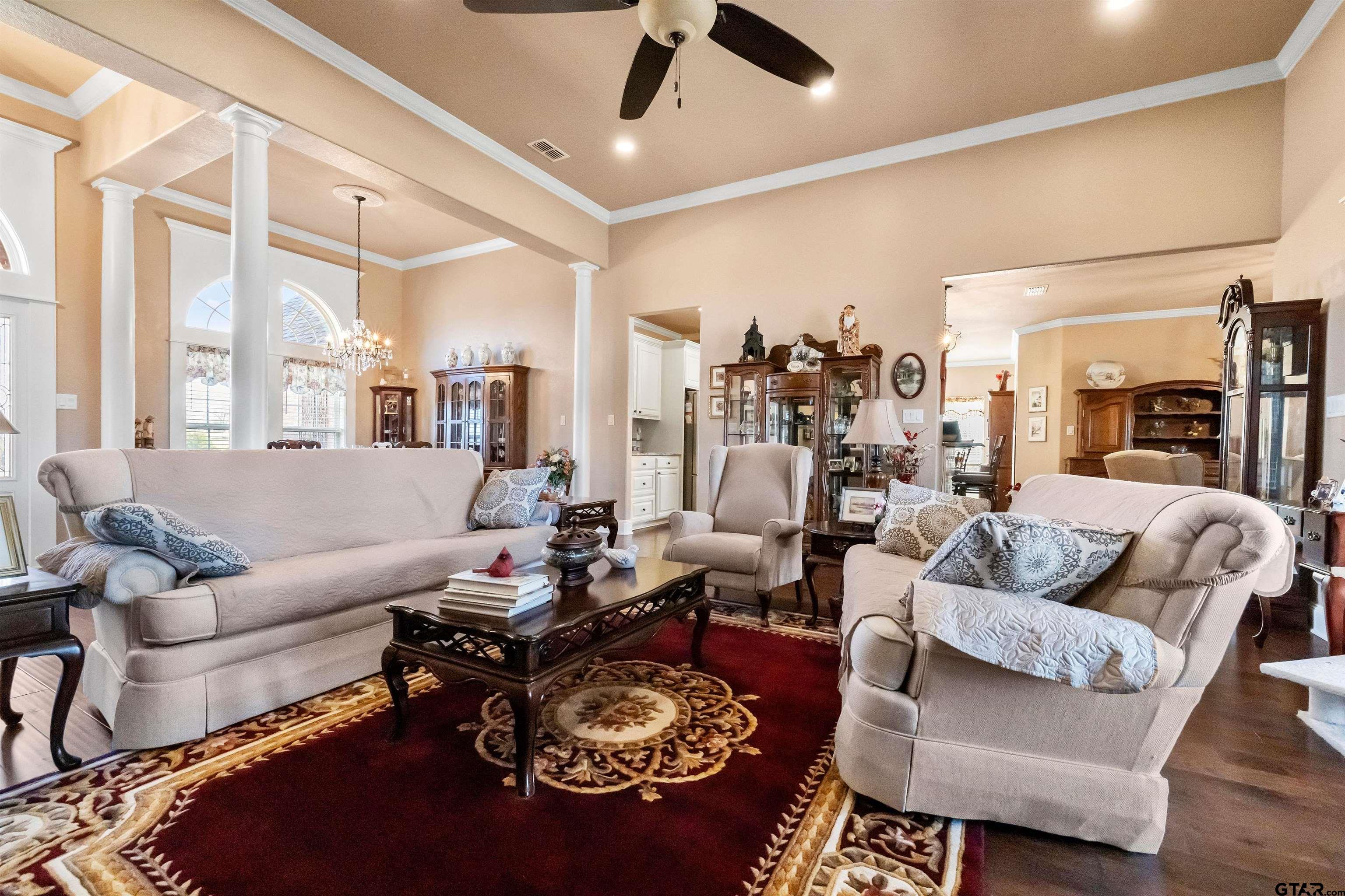 8499 Fm 856 Street Troup, TX 75789 - Photo 13 of 47 a living room with furniture a rug and a chandelier