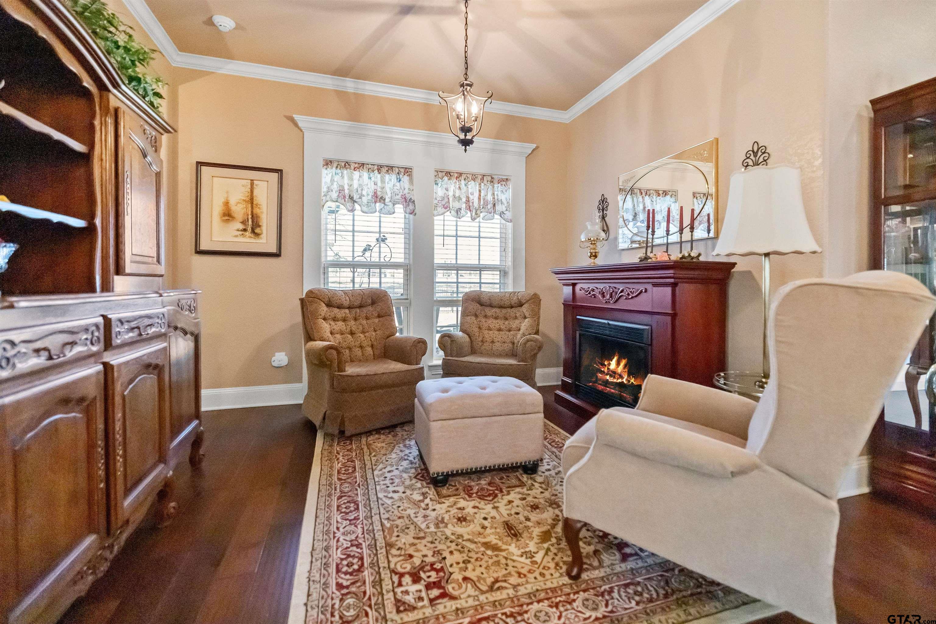 8499 Fm 856 Street Troup, TX 75789 - Photo 16 of 47 a living room with furniture a fireplace and a chandelier