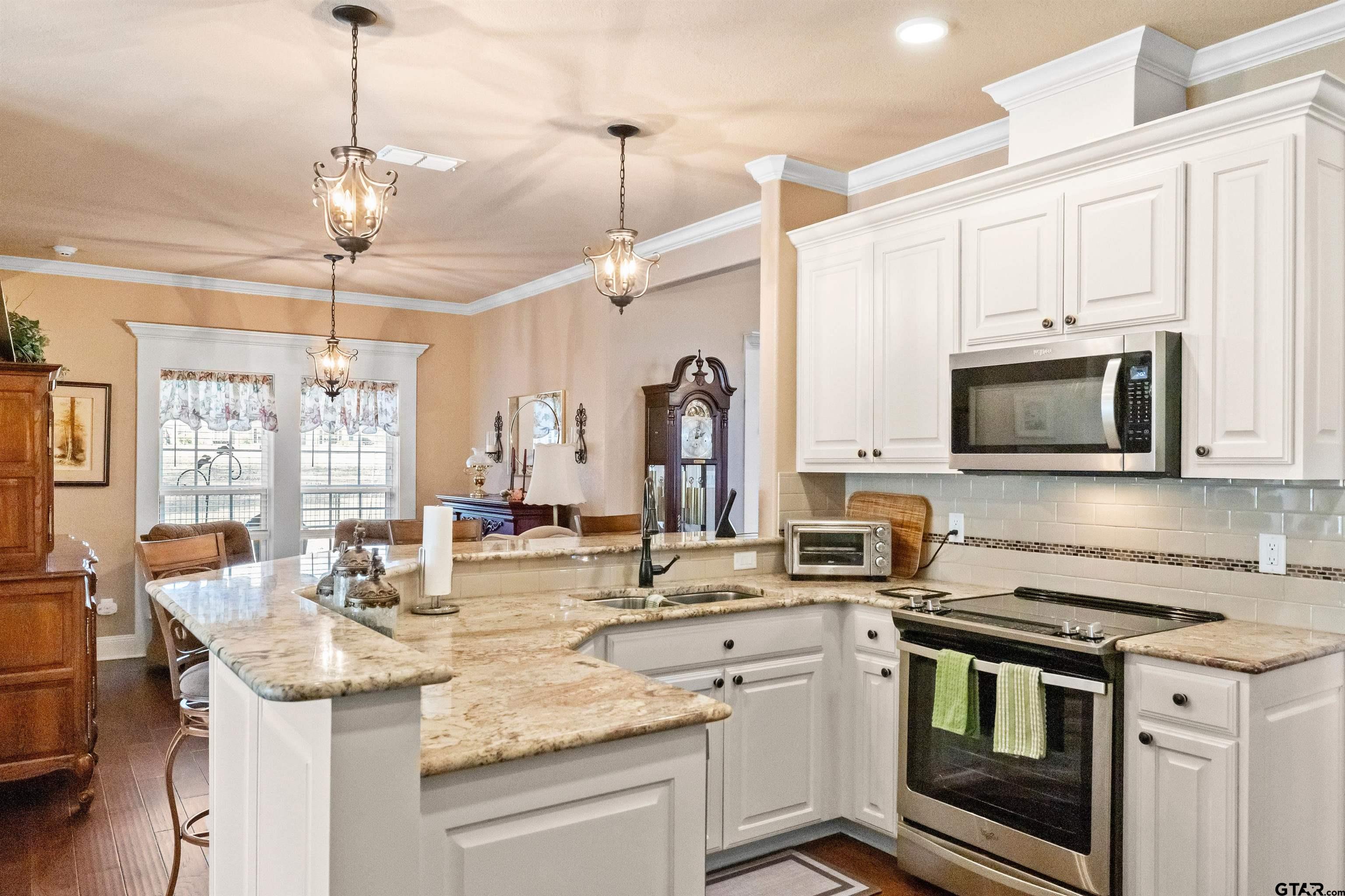 8499 Fm 856 Street Troup, TX 75789 - Photo 17 of 47 a kitchen with stainless steel appliances granite countertop a sink and stove