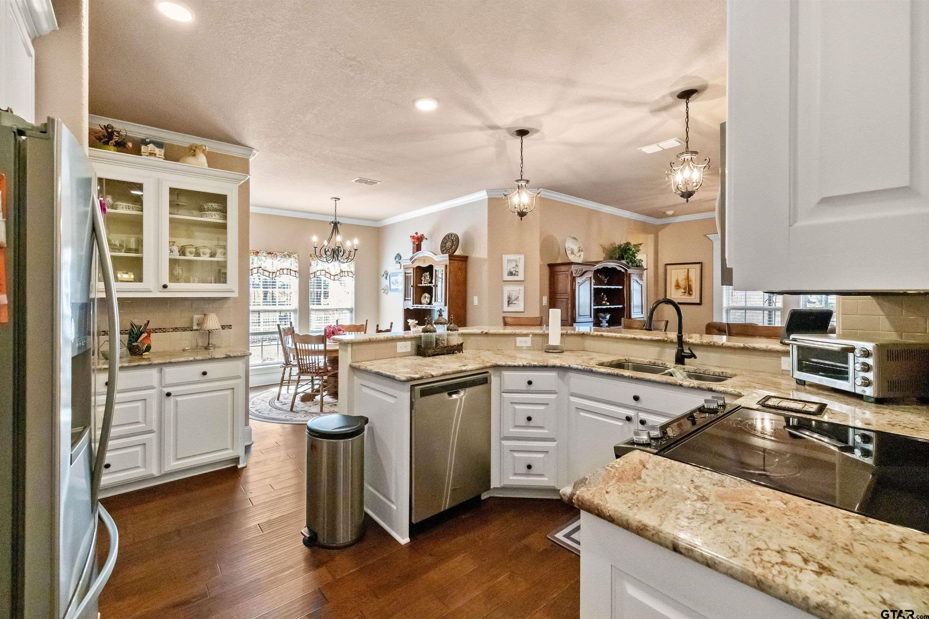 8499 Fm 856 Street Troup, TX 75789 - Photo 18 of 47 a kitchen with granite countertop a sink stainless steel appliances and cabinets