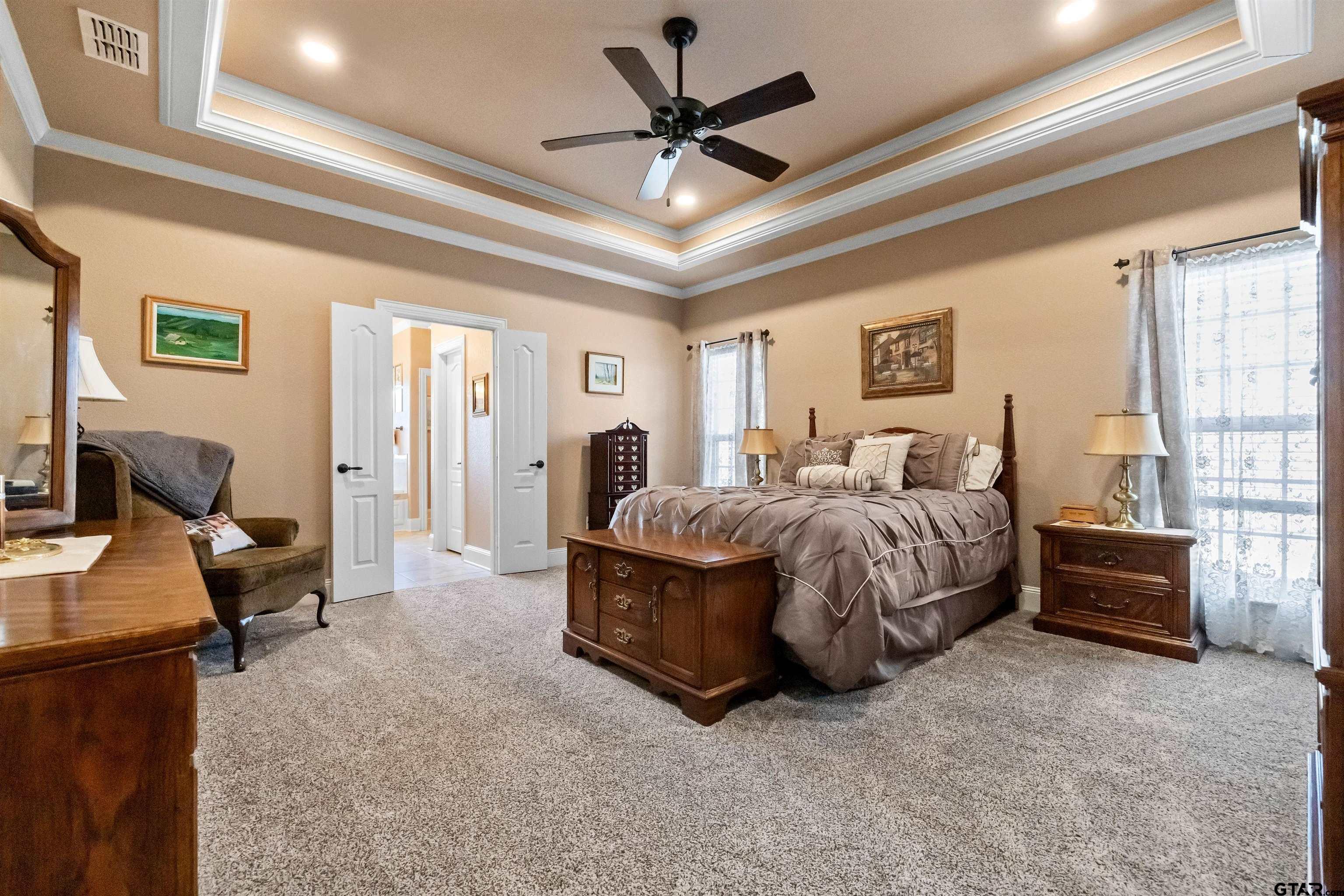 8499 Fm 856 Street Troup, TX 75789 - Photo 22 of 47 a spacious bedroom with a bed and a couch