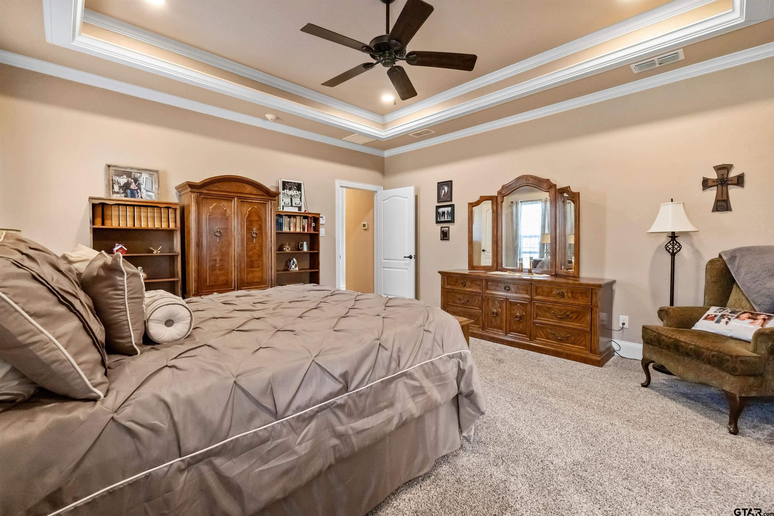 8499 Fm 856 Street Troup, TX 75789 - Photo 23 of 47 a bedroom with a bed dresser and a chandelier