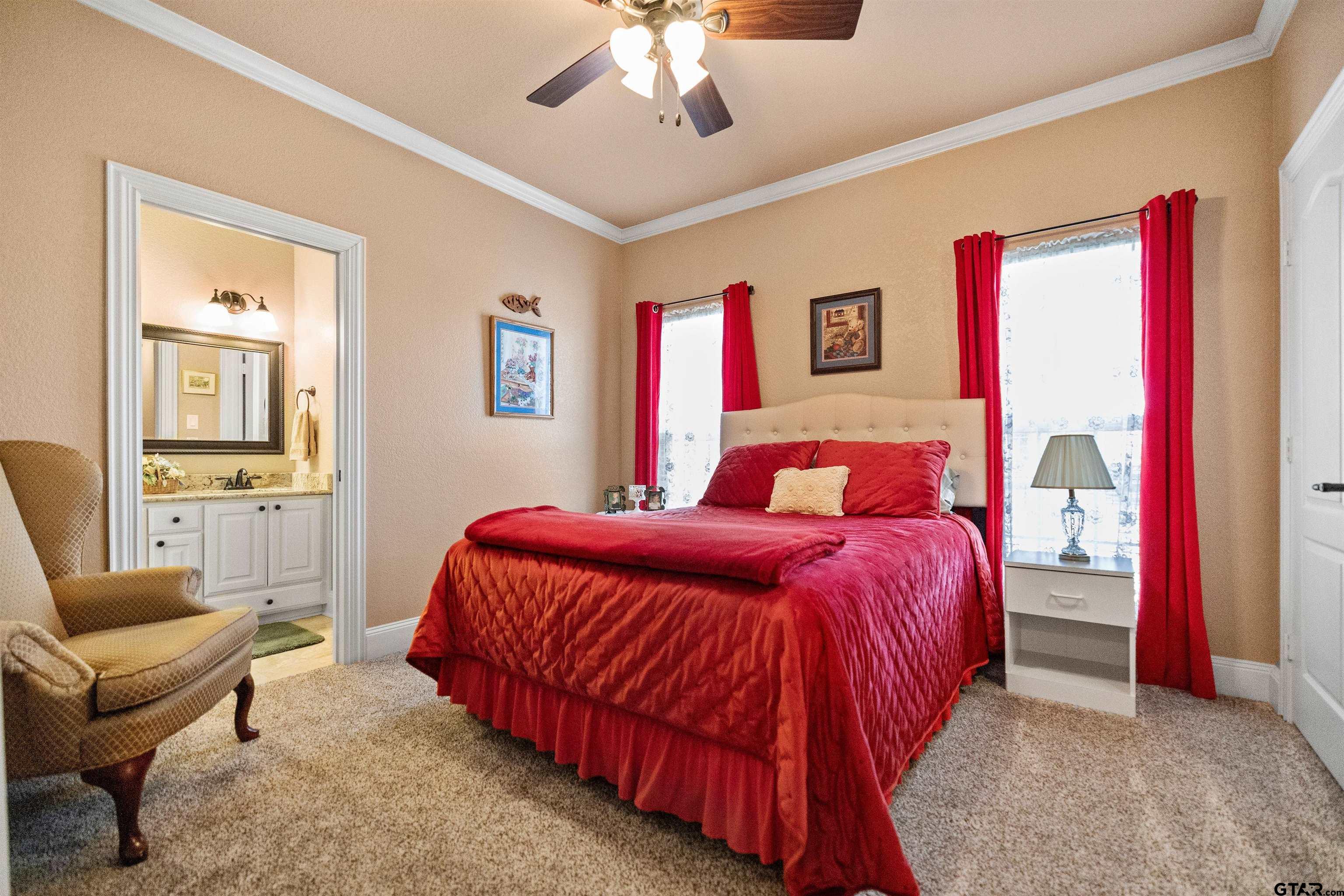 8499 Fm 856 Street Troup, TX 75789 - Photo 27 of 47 a bedroom with a bed and a chandelier
