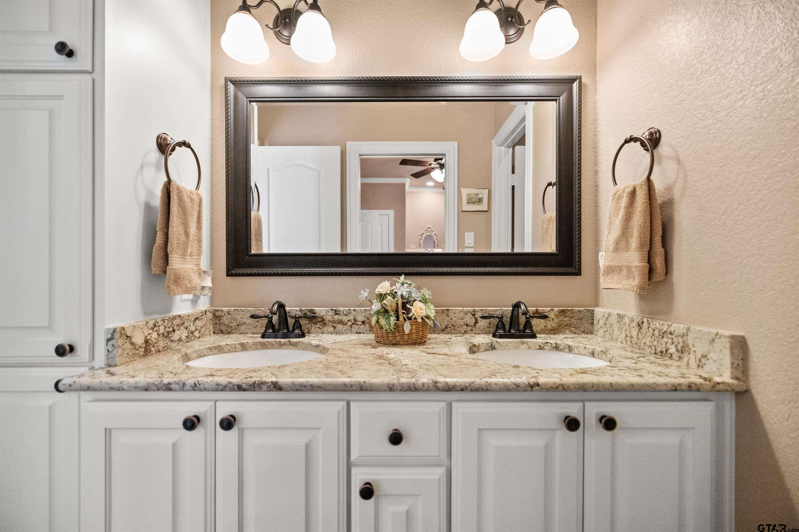 8499 Fm 856 Street Troup, TX 75789 - Photo 28 of 47 a bathroom with a granite countertop sink two mirror and a