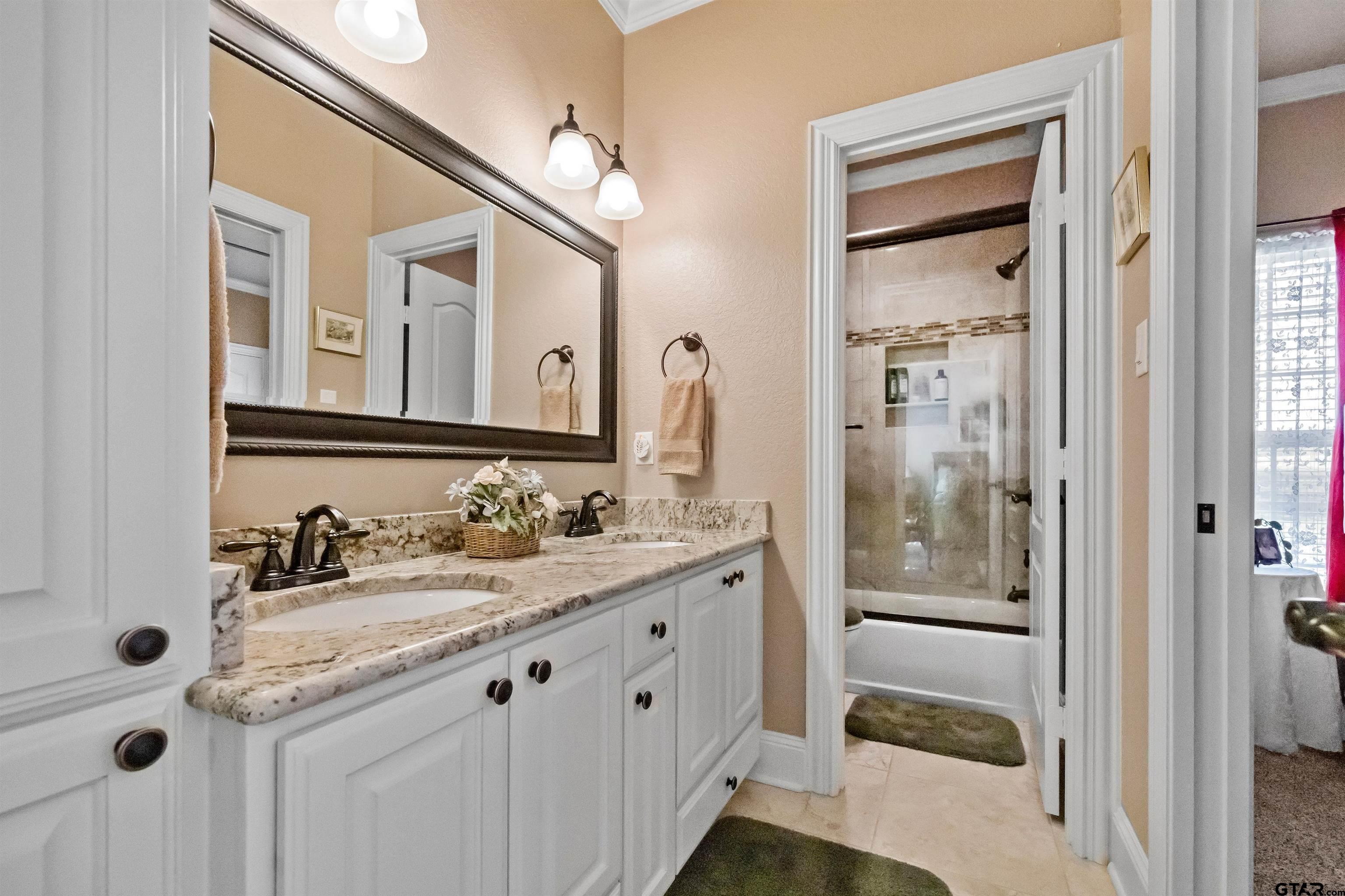 8499 Fm 856 Street Troup, TX 75789 - Photo 29 of 47 a bathroom with a double vanity sink and mirror