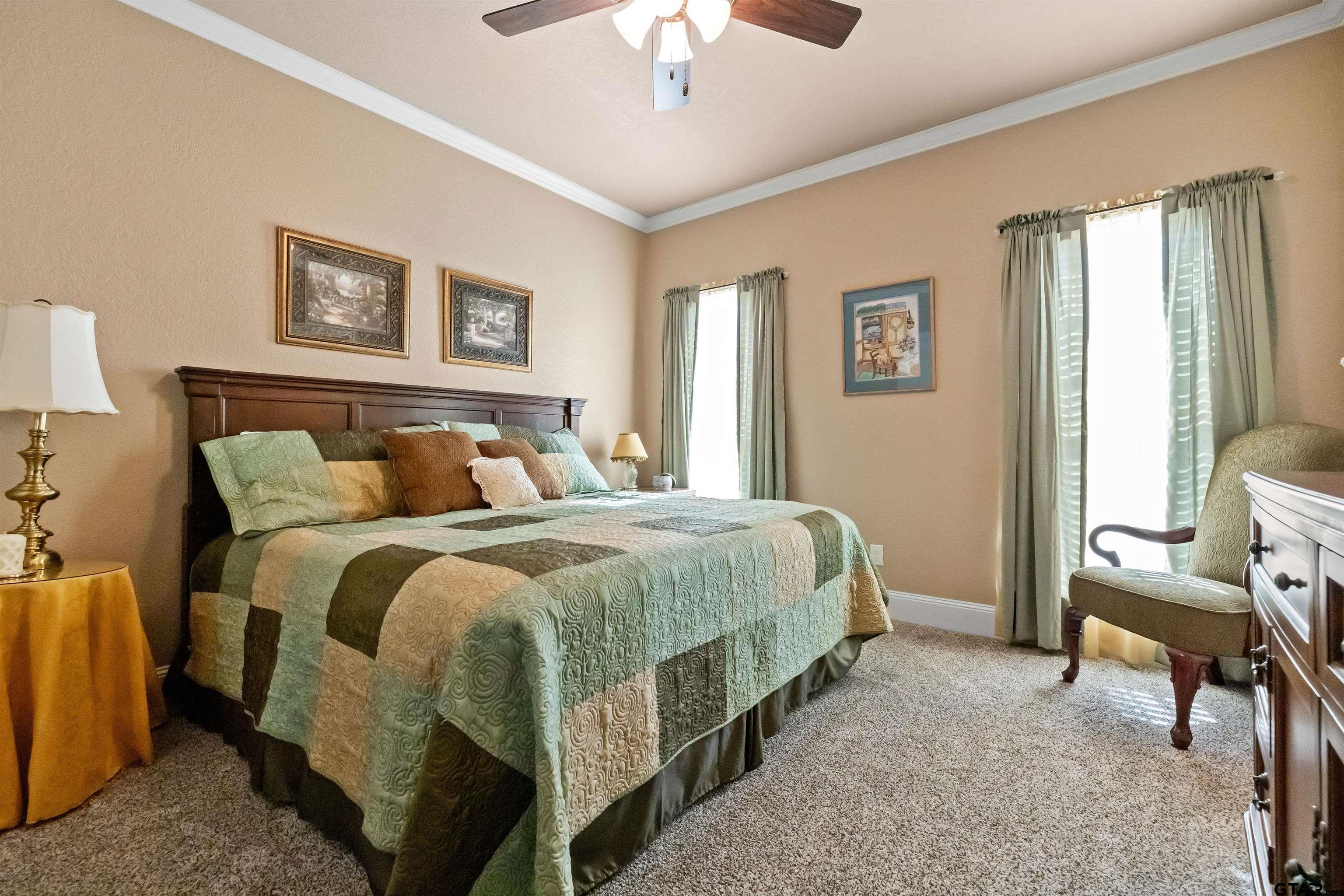 8499 Fm 856 Street Troup, TX 75789 - Photo 30 of 47 a bedroom with a bed and a chandelier