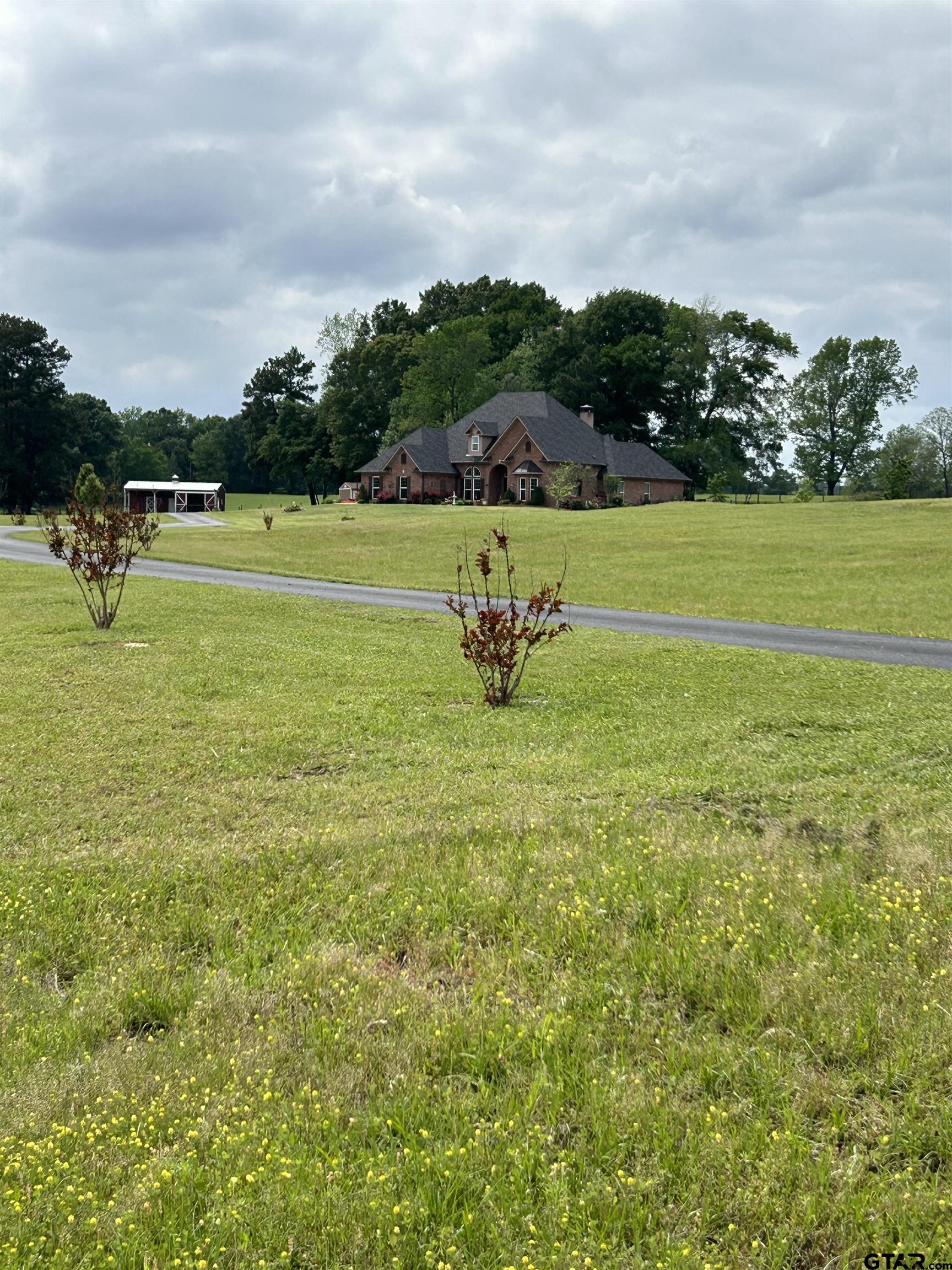 8499 Fm 856 Street Troup, TX 75789 - Photo 4 of 47 a view of a golf course with a garden