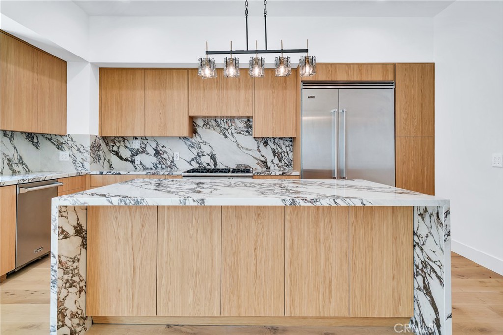 13838 Milbank Street Sherman Oaks, CA 91423 - Photo 12 of 57 a bathroom with a granite countertop sink and a mirror