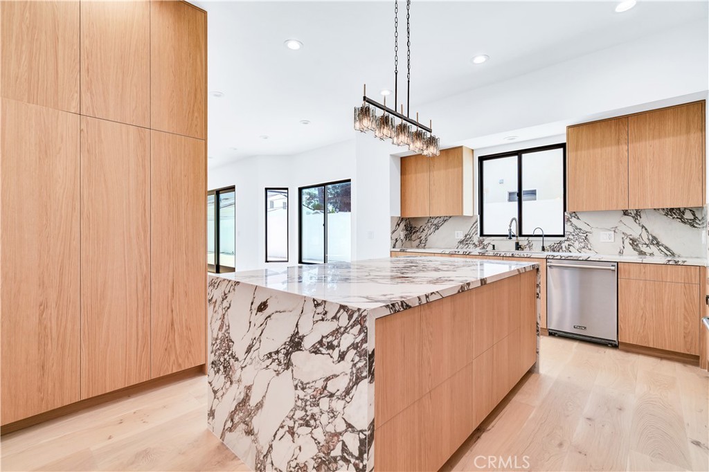 13838 Milbank Street Sherman Oaks, CA 91423 - Photo 16 of 57 a kitchen with granite countertop a sink window and cabinets
