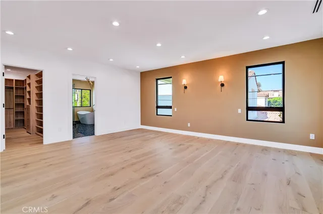 a view of walk in closet with empty racks