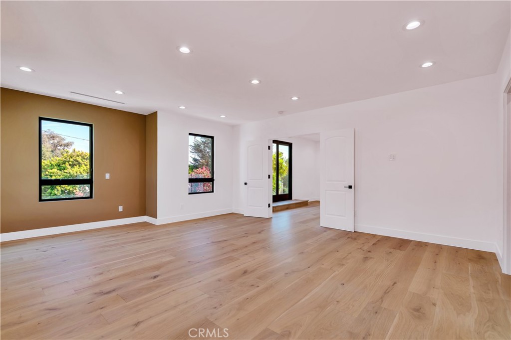 13838 Milbank Street Sherman Oaks, CA 91423 - Photo 23 of 57 an empty room with window and wooden floor