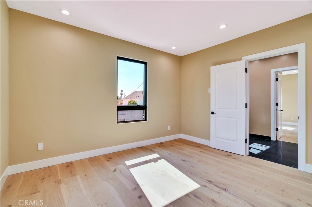 13838 Milbank Street Sherman Oaks, CA 91423 - Photo 30 of 57 an empty room with wooden floor and windows