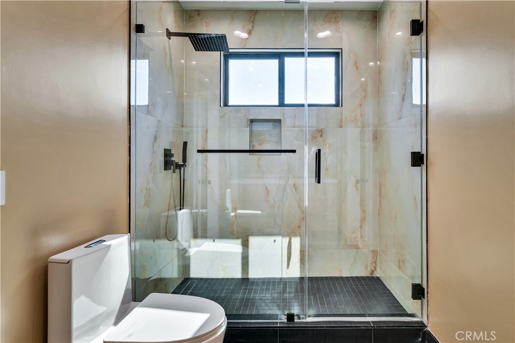 13838 Milbank Street Sherman Oaks, CA 91423 - Photo 32 of 57 a bathroom with a granite countertop shower a toilet and a sink