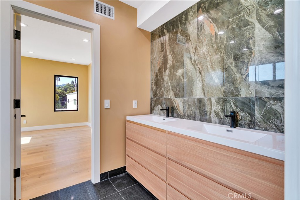 13838 Milbank Street Sherman Oaks, CA 91423 - Photo 33 of 57 a bathroom with a sink and a mirror