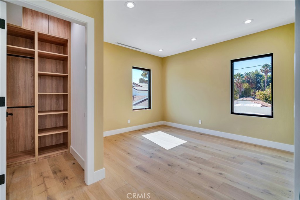 13838 Milbank Street Sherman Oaks, CA 91423 - Photo 35 of 57 a view of an empty room with wooden floor and closet