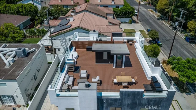 an aerial view of multiple houses with a street