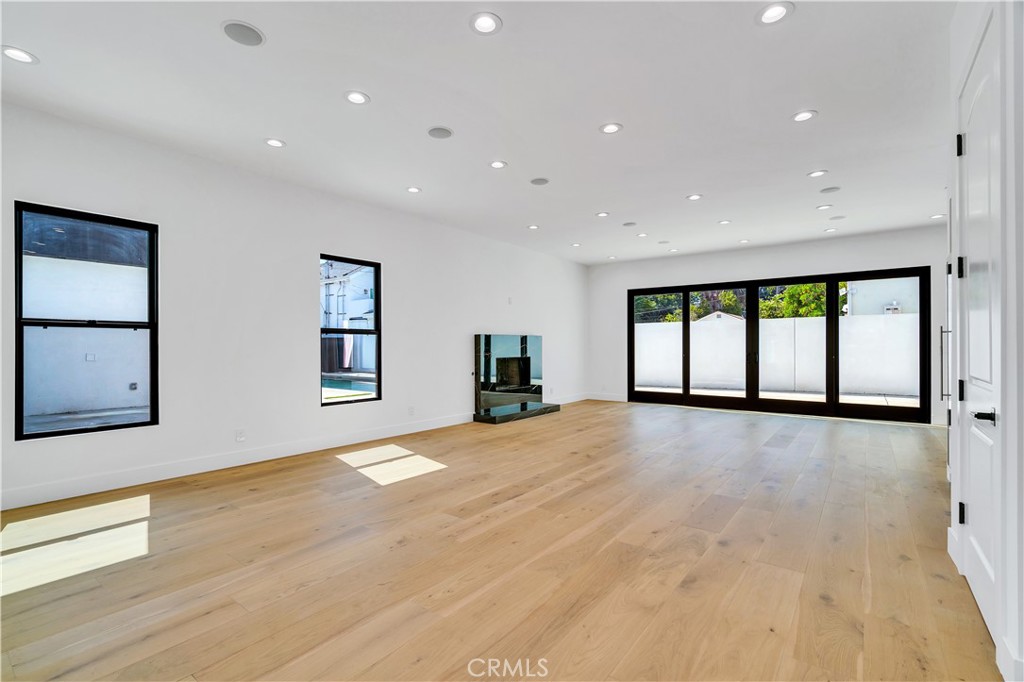 13838 Milbank Street Sherman Oaks, CA 91423 - Photo 5 of 57 a view of an empty room with a window and wooden floor