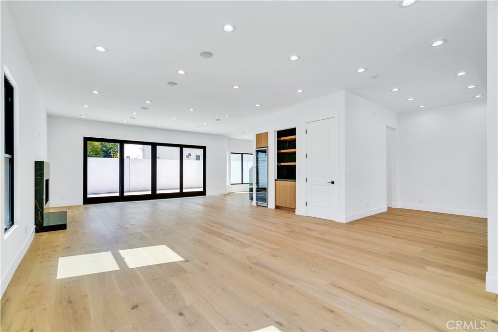 13838 Milbank Street Sherman Oaks, CA 91423 - Photo 6 of 57 a view of an empty room with a window and wooden floor
