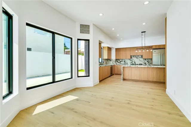 a kitchen with kitchen island granite countertop a sink a counter top space and cabinets