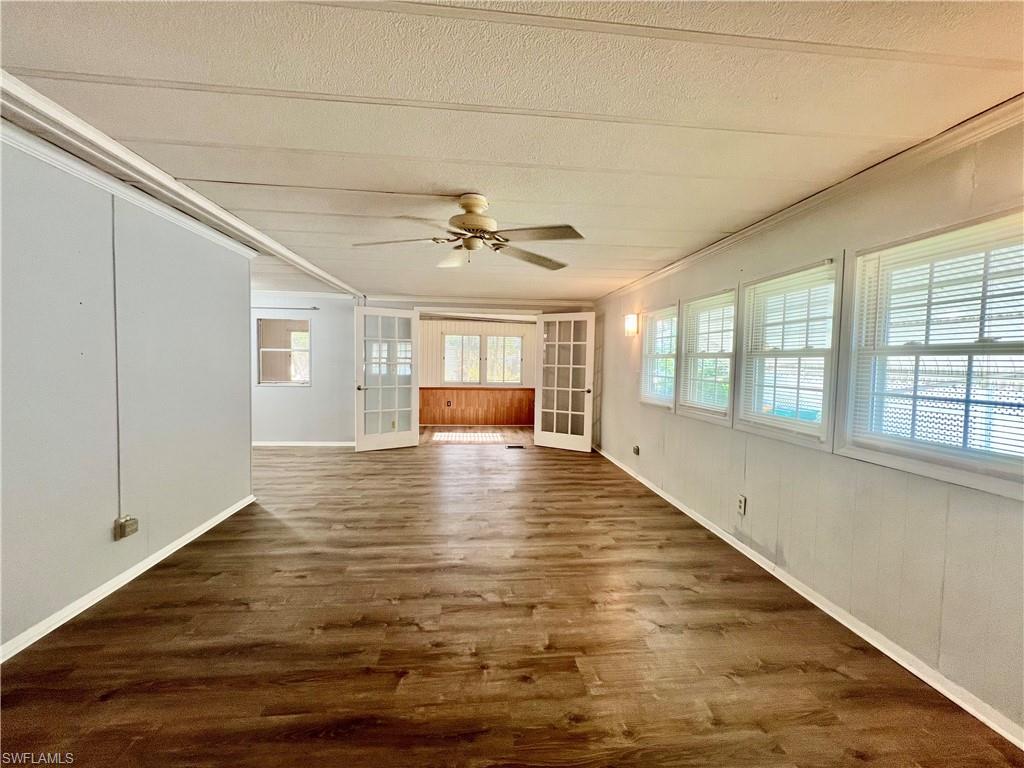 13 Cannes Drive Naples, FL 34112 - Photo 15 of 50 a view of empty room with wooden floor and fan