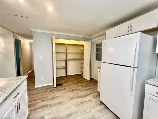 a kitchen with a refrigerator and a sink