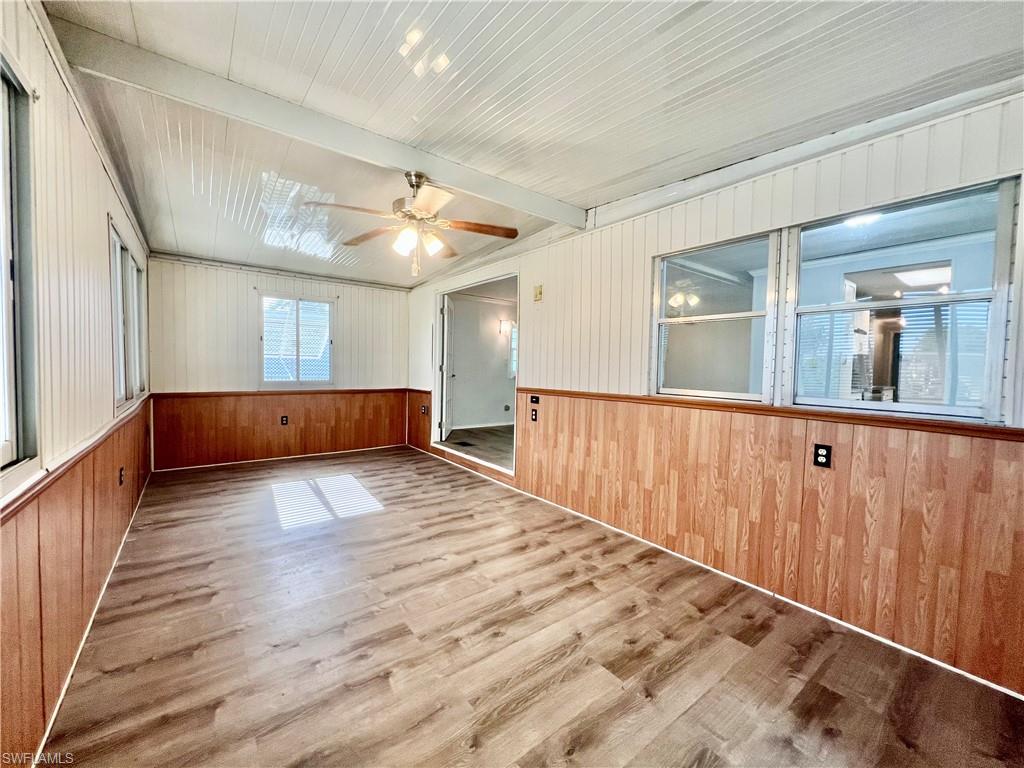 13 Cannes Drive Naples, FL 34112 - Photo 22 of 50 a view of a hallway with wooden floor and staircase