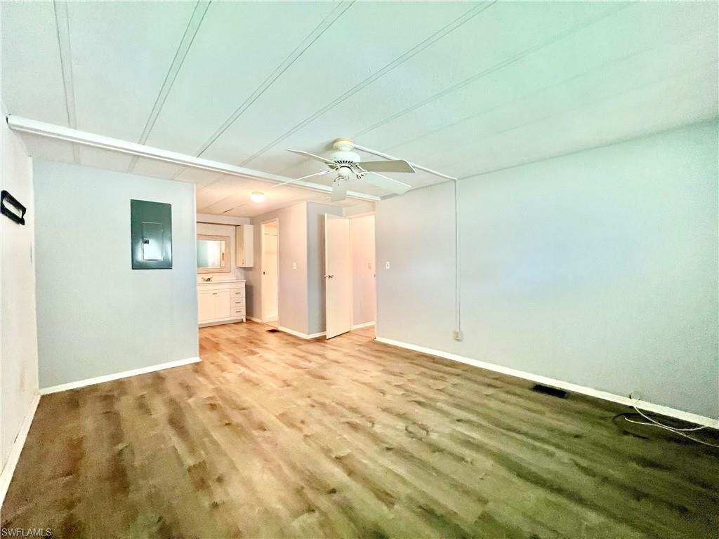 13 Cannes Drive Naples, FL 34112 - Photo 30 of 50 a view of a big room with wooden floor and windows