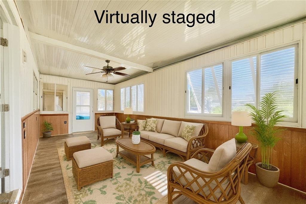 13 Cannes Drive Naples, FL 34112 - Photo 3 of 50 a living room with furniture and a large window