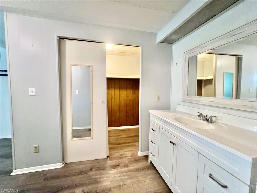 13 Cannes Drive Naples, FL 34112 - Photo 33 of 50 a bathroom with a sink and a mirror