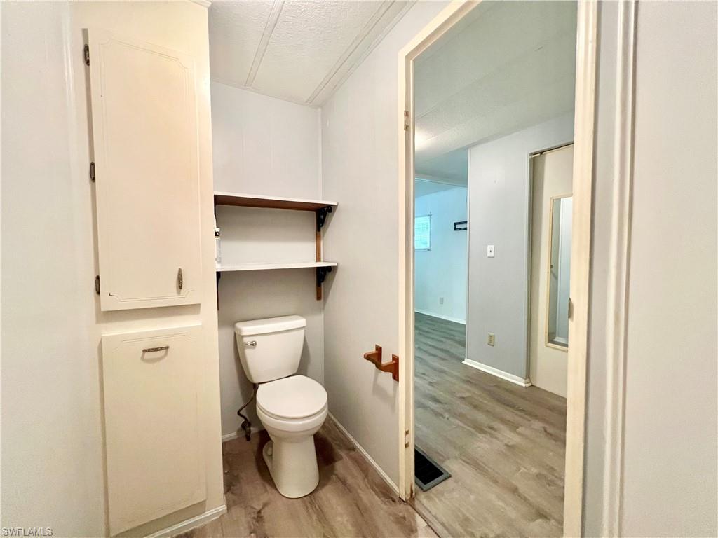 13 Cannes Drive Naples, FL 34112 - Photo 34 of 50 a bathroom with a toilet and a shower