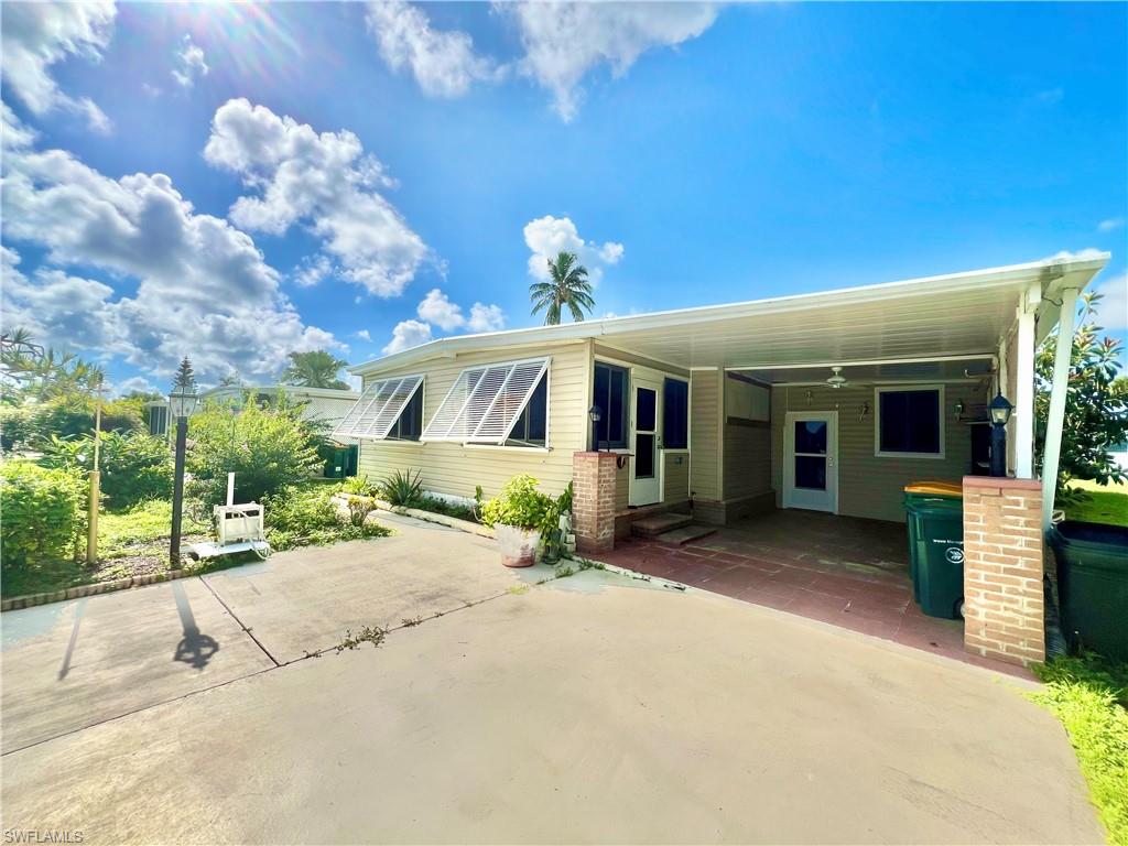 13 Cannes Drive Naples, FL 34112 - Photo 37 of 50 a front view of a house with garden