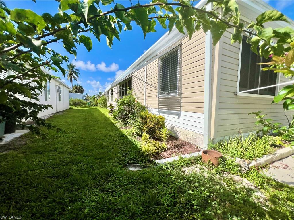 13 Cannes Drive Naples, FL 34112 - Photo 39 of 50 a backyard of a house with lots of green space