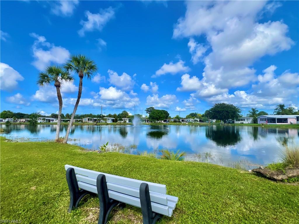 13 Cannes Drive Naples, FL 34112 - Photo 40 of 50 a view of a lake with a yard