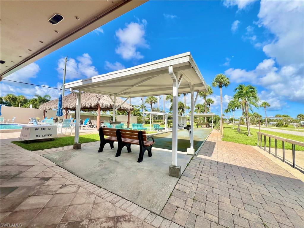 13 Cannes Drive Naples, FL 34112 - Photo 41 of 50 a view of a patio with a table and chairs