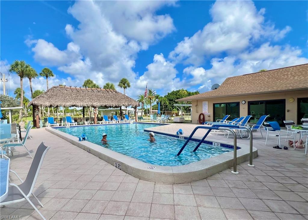 13 Cannes Drive Naples, FL 34112 - Photo 43 of 50 a view of a house with backyard porch and sitting area