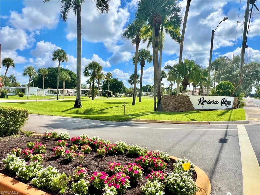 13 Cannes Drive Naples, FL 34112 - Photo 50 of 50 a view of a swimming pool with a yard and palm trees