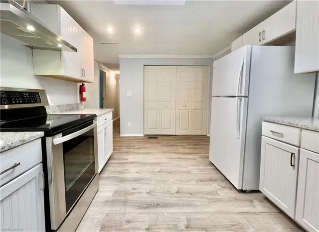 a kitchen with stainless steel appliances a refrigerator sink and stove