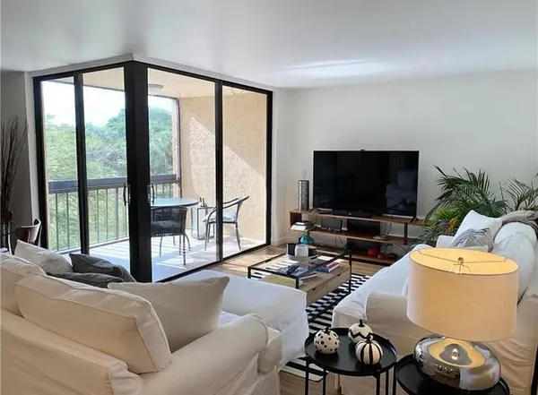 a view of a kitchen with kitchen island a sink and a large window