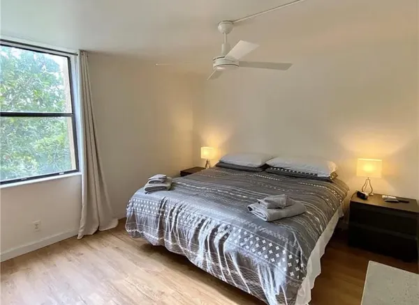 a living room with furniture and a floor to ceiling window