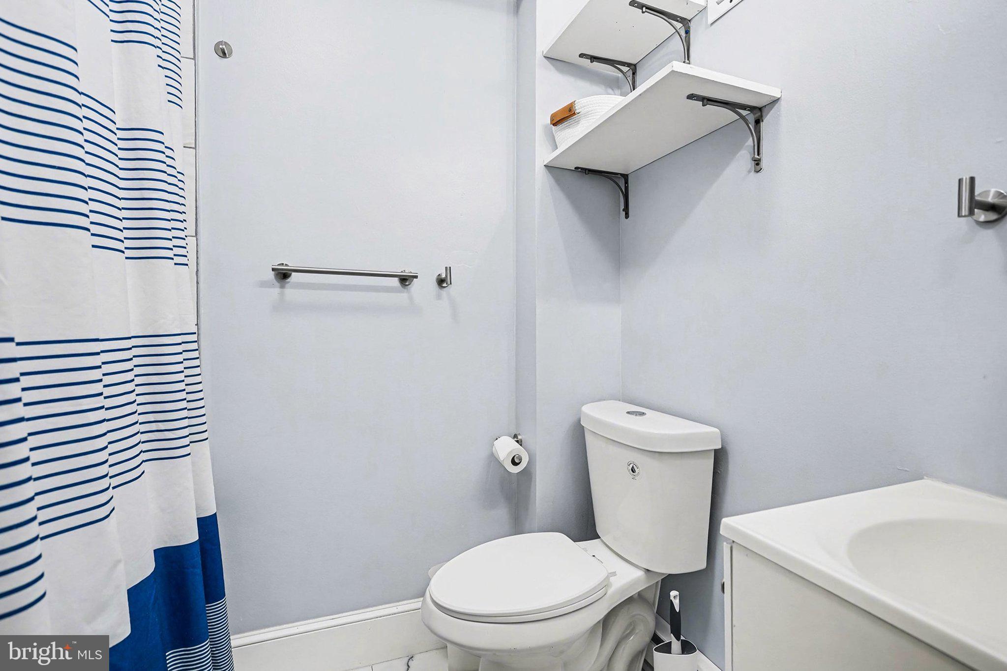 353 East Marion Street Lancaster, PA 17602 - Photo 21 of 28 a white toilet sitting next to a bathroom sink