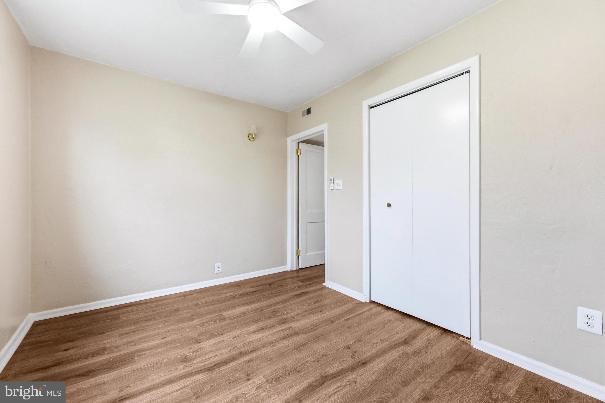 3 Victory Street Aberdeen, MD 21001 - Photo 14 of 26 an empty room with wooden floor and a ceiling fan