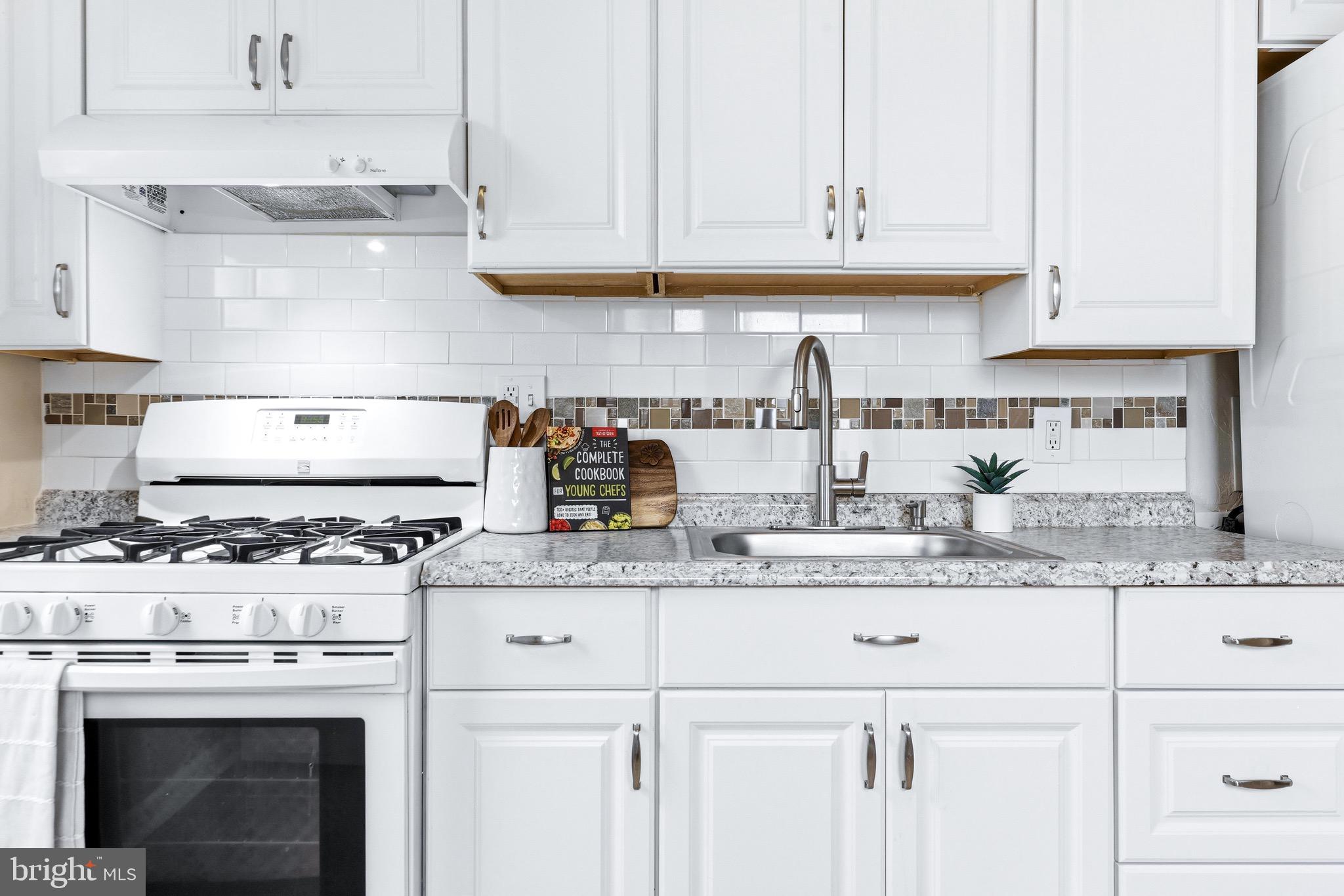 3 Victory Street Aberdeen, MD 21001 - Photo 2 of 26 a kitchen with granite countertop a stove sink and cabinets