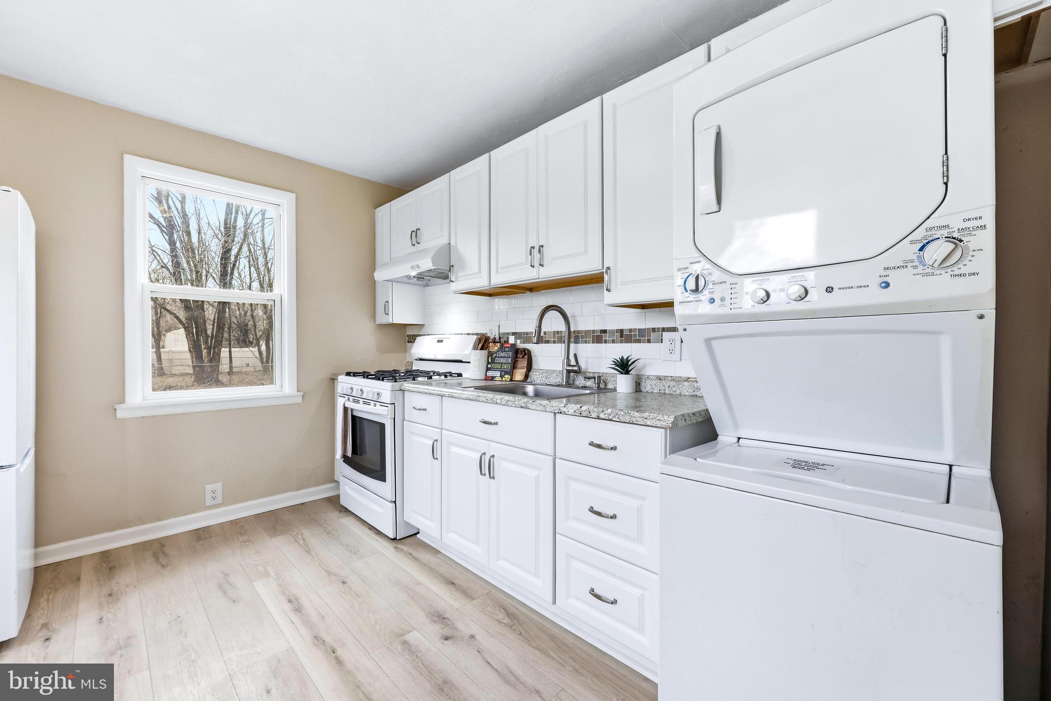 3 Victory Street Aberdeen, MD 21001 - Photo 4 of 26 a kitchen with granite countertop white cabinets and white appliances
