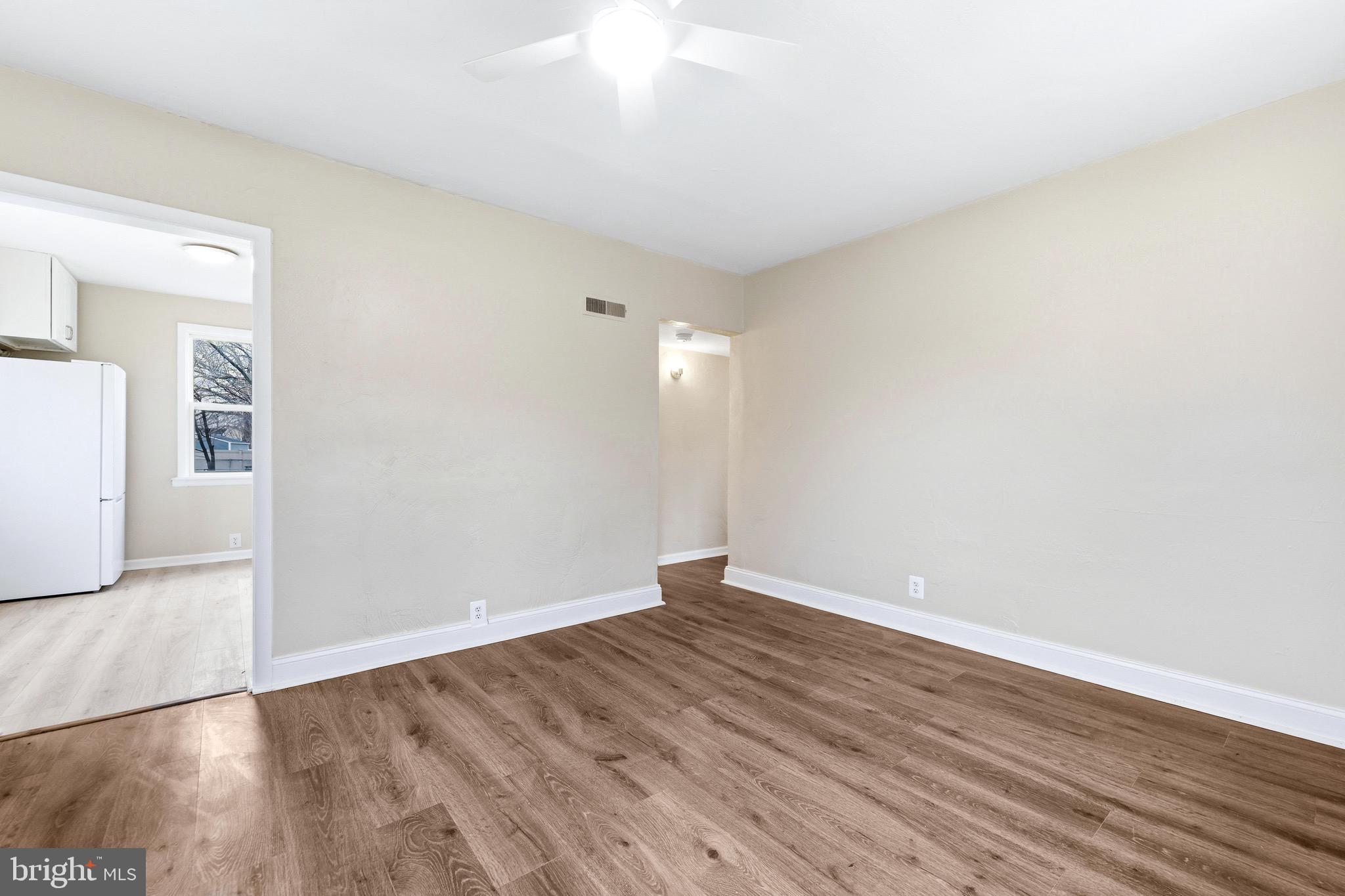 3 Victory Street Aberdeen, MD 21001 - Photo 9 of 26 a view of an empty room with wooden floor and a window